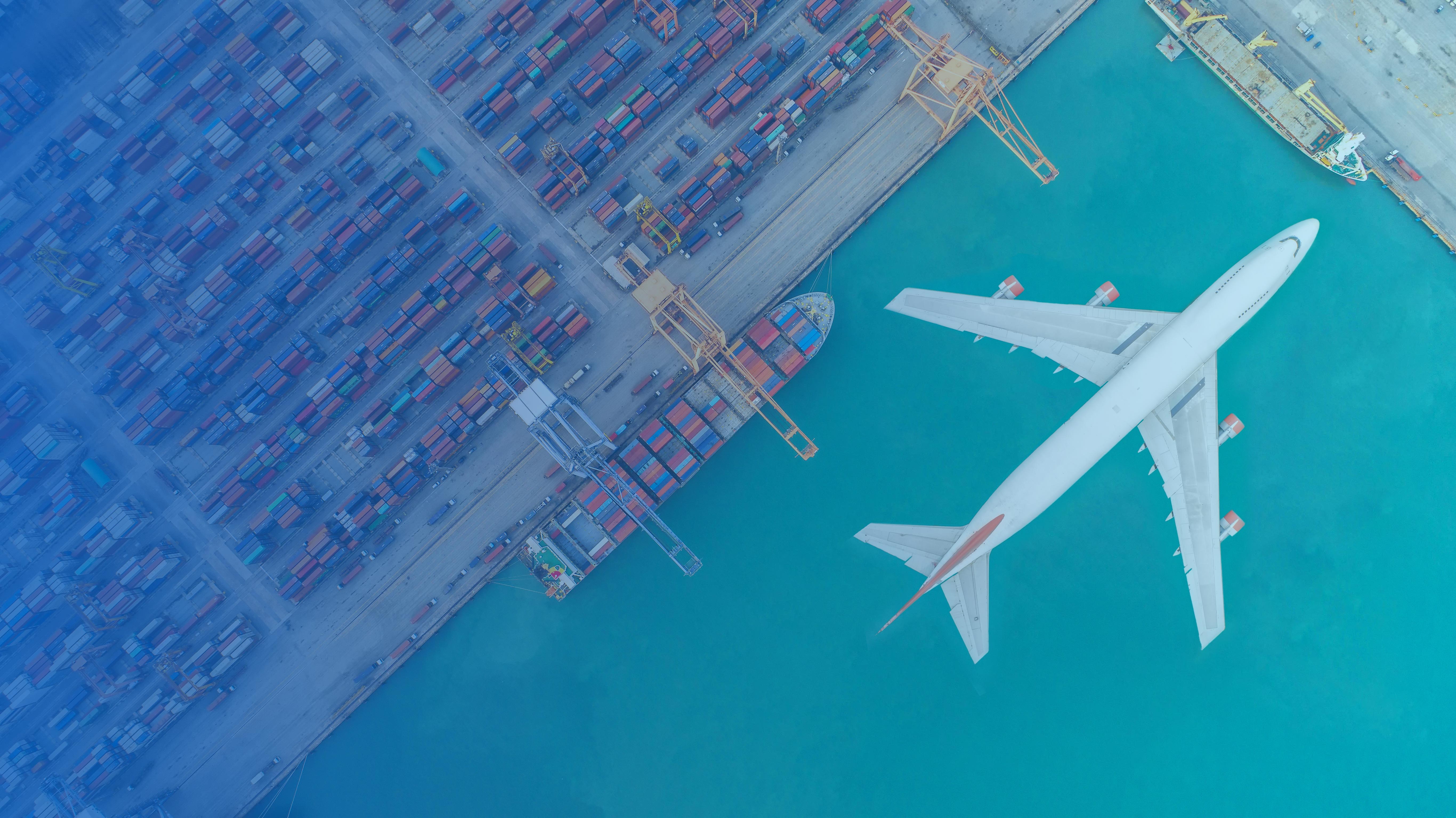Aerial view of airplane over container port